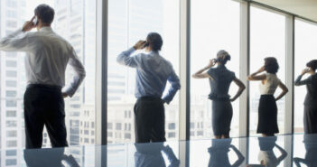 Business people using cell phones in conference room