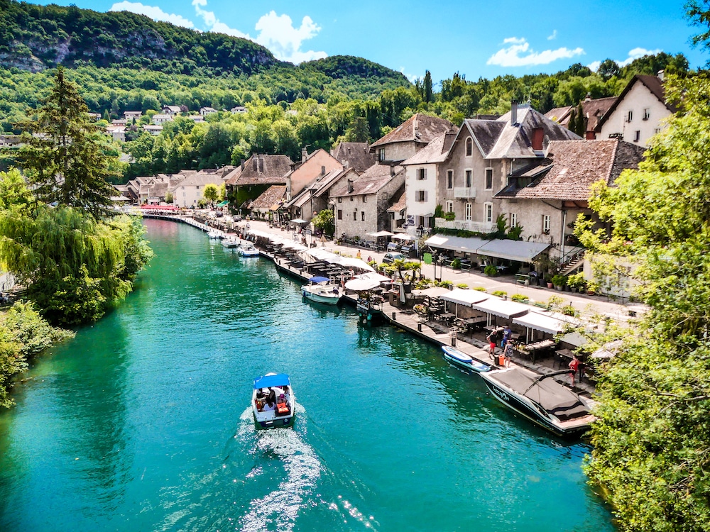 High Angle View Of River Amidst Buildings And Mountains